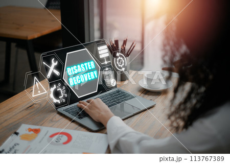 Disaster recovery concept, Buinesswoman using laptop computer on desk with disaster recovery icon on virtual screen. 113767389