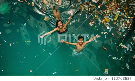 Two people swimming in the sea full of plastic waste 113768687