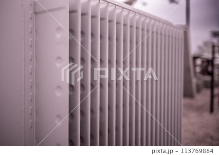 Selective focus on an electric transformer outside a commercial building. Selective focus on an electric transformer outside a commercial building. 113769884