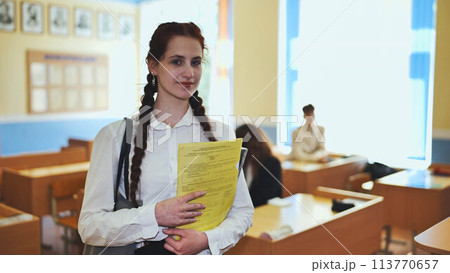 Portrait of a high school girl with notebooks. 113770657