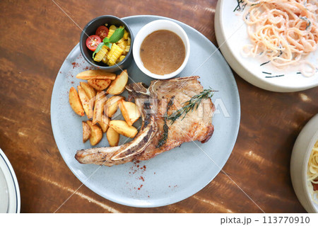 pork chop or grilled pork with French fries and salad pork chop or grilled pork with French fries and salad 113770910