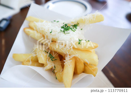 French fries or fried potato ,cheese fries or french fries with cheese topping 113770911