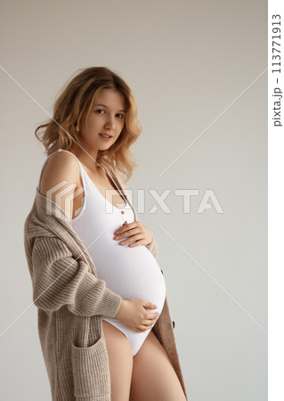 A beautiful pregnant girl in a white bodysuit and A beautiful pregnant girl in a white bodysuit and 113771913