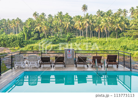 View of swimming pool in hotel nearly riverside in Pinnawala village, Sri Lanka. Pinnawala is the best place to see largest herd of captive elephants in the world. View of swimming pool in hotel nearly riverside in Pinnawala village, Sri Lanka. Pinnawala is the best place to see largest herd of captive elephants in the world. 113773113