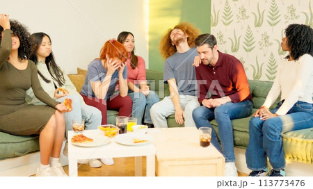Friends witnessing the end of a match, their team losing 113773476