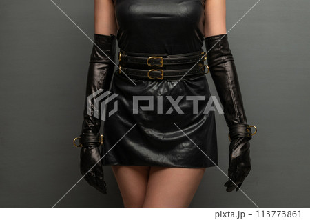 Beautiful young woman in a leather dress and bondage set posing 113773861