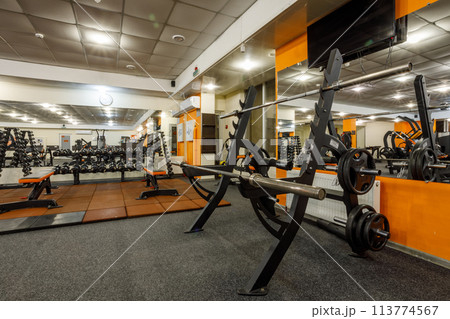 Exercise equipment in an empty gym Exercise equipment in an empty gym 113774567