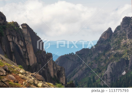 Awesome scenic view to great mountains in distance behind deep gorge. 113775793