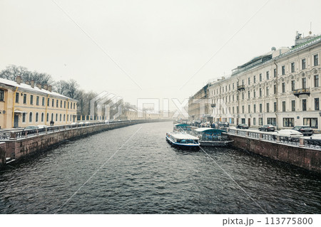 pleasure boat is moored on the river in a spring snowstorm 113775800