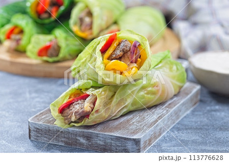 Beef and vegetable cabbage leaves wraps, served with plain yogurt, horizontal Beef and vegetable cabbage leaves wraps, served with plain yogurt, horizontal 113776628