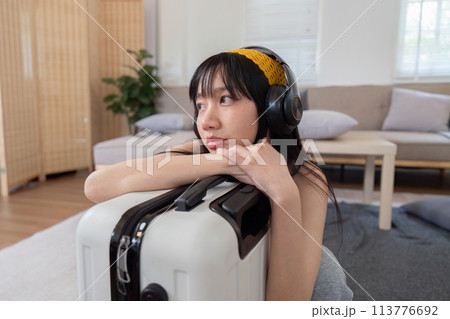 Lonely woman on a hotel bed with suitcase ready for summer vacation. 113776692