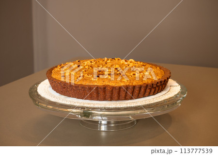 A rich chocolate tart with a luscious hazelnut cream topping A rich chocolate tart with a luscious hazelnut cream topping 113777539