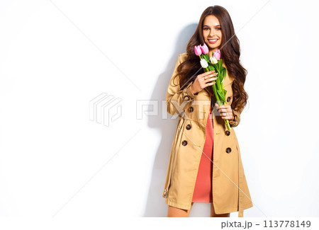 Fashion photo of beautiful woman with tulips in her hand. March 8. beautiful girl in stylish clothes 113778149