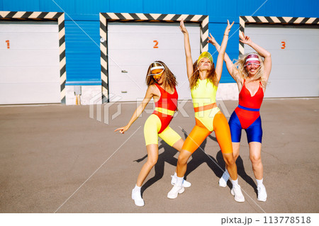 Three young woman in bright swimsuits dancing. Sport, summer, fitness, urban culture concept. 113778518