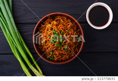 Fried Instant noodles with green onion and soy sauce , traditional asian food Fried Instant noodles with green onion and soy sauce , traditional asian food 113778631