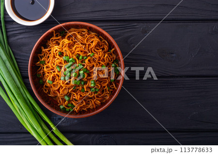 Fried Instant noodles with green onion and soy sauce , traditional asian food Fried Instant noodles with green onion and soy sauce , traditional asian food 113778633