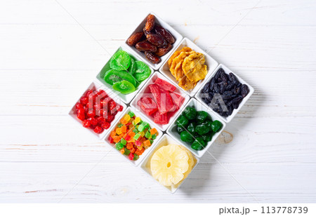 Group of dried and candied fruit in bowl 113778739