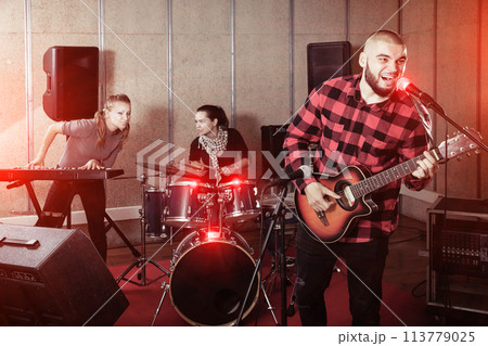 Emotional guy with guitar rehearsing Emotional guy with guitar rehearsing 113779025