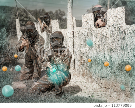 Portrait of team of adult people playing on paintball battlefiel 113779099
