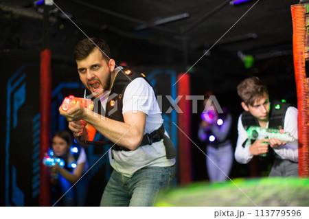 Excited guy during lasertag game 113779596