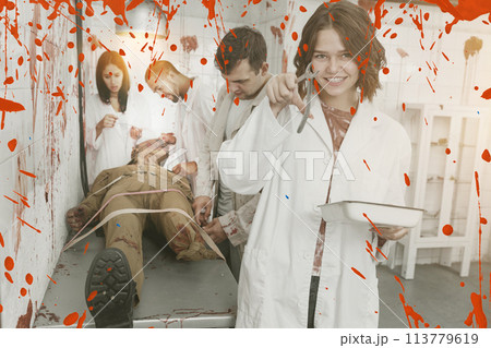 Happy girls in quest room with bloody traces Happy girls in quest room with bloody traces 113779619