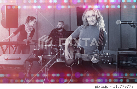 excited girl rock singer with guitar during rehearsal excited girl rock singer with guitar during rehearsal 113779778