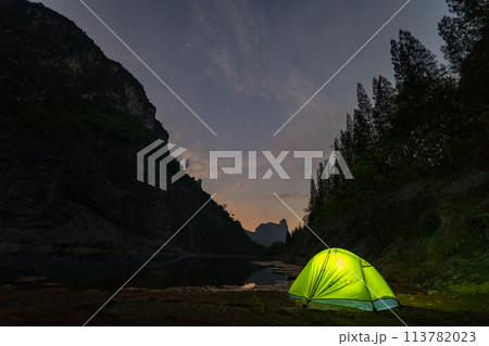 A yellow tent stood beside a large pond in the mining area. 113782023