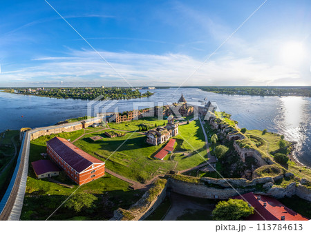 Europe. Russia, Leningrad region, St. Petersburg, Aerial panoramic view on fortress Oreshek near Schlesselburg town. Ancient Russian fort on island in Ladoga lake in sunny summery day Europe. Russia, Leningrad region, St. Petersburg, Aerial panoramic view on fortress Oreshek near Schlesselburg town. Ancient Russian fort on island in Ladoga lake in sunny summery day 113784613