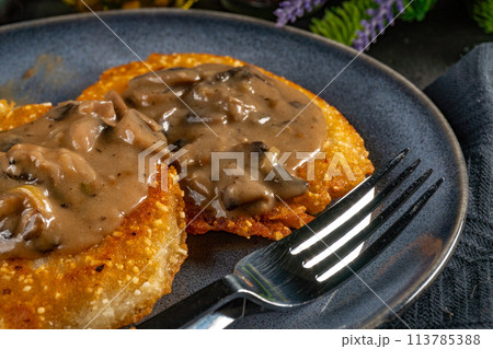 Crispy potato pancakes with mushroom sauce 113785388