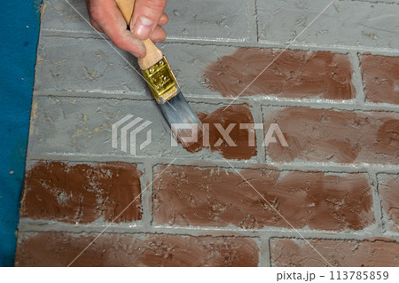 creation of artificial bricks, the process of painting a photographic background 113785859