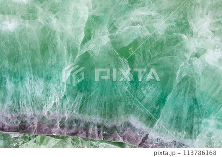 Green Fluorite. Gemstone background. Matt natural semi precious mineral pattern. Green Fluorite. Gemstone background. Matt natural semi precious mineral pattern. 113786168