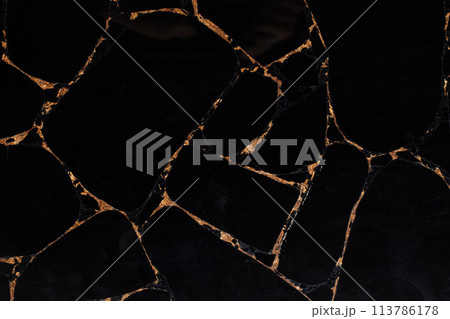Black Obsidian stone texture with gold leaf, semi precious background. 113786178