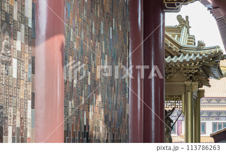 Golden gable roof and slab of colored tiles on temple wall at Fo Guang Shan Thaihua Temple. 113786263
