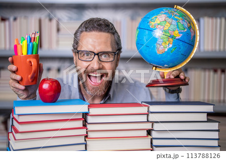 Tutor at classroom. Man geographer with books in classroom. Knowledge and education concept. school teacher with book in classroom. teacher in classroom. Teachers Day. learning and discovery Tutor at classroom. Man geographer with books in classroom. Knowledge and education concept. school teacher with book in classroom. teacher in classroom. Teachers Day. learning and discovery 113788126