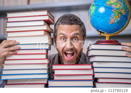 nerd man in classroom. bookworm in school library. education and knowledge. man teacher in class. school education. man nerd with school book. school literature education. Absorbed in a book 113788129