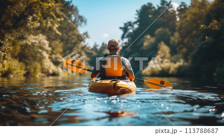 Kayaking on a serene river, amidst a green forest, under a clear blue sky, captured mid-action Kayaking on a serene river, amidst a green forest, under a clear blue sky, captured mid-action 113788687