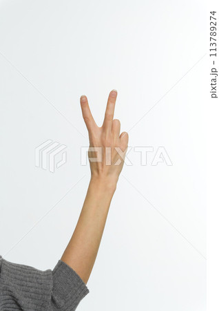 Female hand showing peace sign or victory sign. 113789274