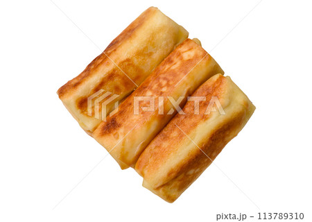 Delicious fried pancakes with filling rolled on a dark concrete background Delicious fried pancakes with filling rolled on a dark concrete background 113789310