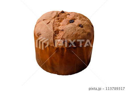 Delicious sweet holiday panettone cake with zest and raisins on a ceramic plate Delicious sweet holiday panettone cake with zest and raisins on a ceramic plate 113789317