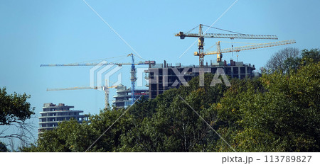 Kiev, Ukraine January 19, 2021: Tower construction cranes on the construction of high-rise buildings Kiev, Ukraine January 19, 2021: Tower construction cranes on the construction of high-rise buildings 113789827