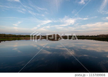 Boardwalk and sunrise cloudscape over wetlands of Green Cay Nature Center. Boardwalk and sunrise cloudscape over wetlands of Green Cay Nature Center. 113789908