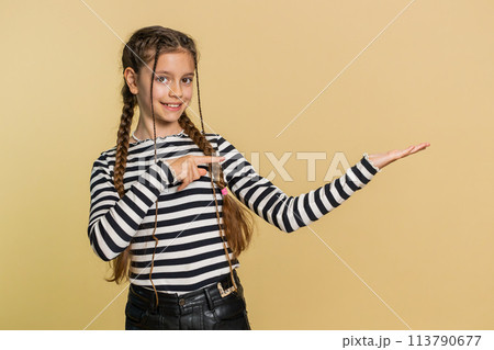 Child girl kid showing thumbs up and pointing on blank space place for advertisement promotion logo 113790677