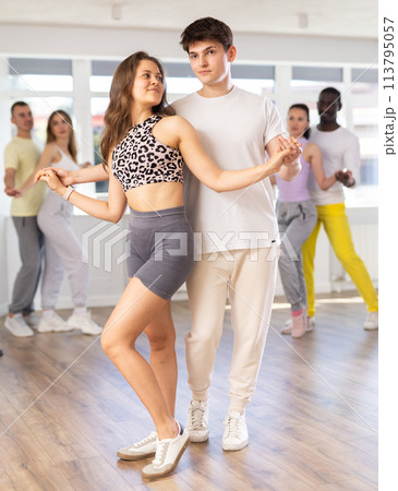 Men and women of different nationalities dancing salsa o bachata in dance hall Men and women of different nationalities dancing salsa o bachata in dance hall 113795057