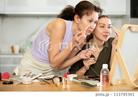 Woman doing eyebrow makeup with brush Woman doing eyebrow makeup with brush 113795361
