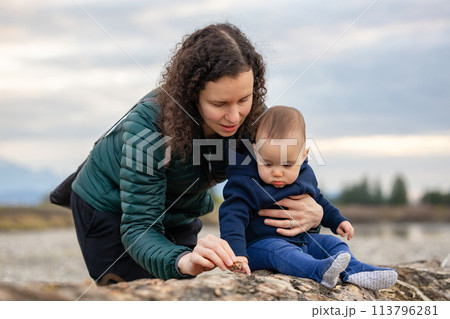 Mother and Baby Boy outside in nature by the river. Mother and Baby Boy outside in nature by the river. 113796281