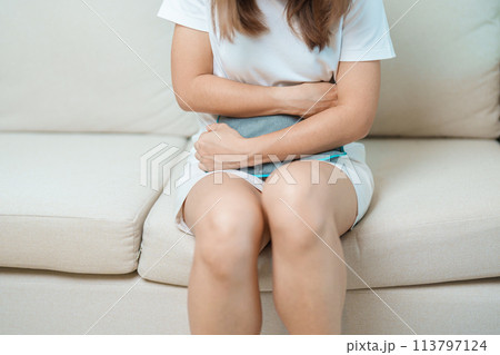 Menstruation period cycle of monthly and Stomachache concepts. woman having abdomen pain and menstrual ache with hot water bottle, illness female suffer from premenstrual ache and body Health problem Menstruation period cycle of monthly and Stomachache concepts. woman having abdomen pain and menstrual ache with hot water bottle, illness female suffer from premenstrual ache and body Health problem 113797124