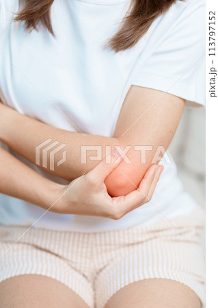 Woman having elbow ache at home, muscle pain due to lateral epicondylitis or tennis elbow. injury, Health and medical concept 113797152