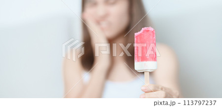 Teeth Sensitive to Cold concept. woman hold Ice cream and having toothache and pain after eat. Tooth Decay or Gum Disease, Grinding Teeth and Stress, Exposed Nerve Roots, Crack and Receding Gums 113797237