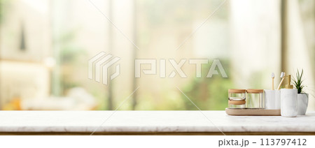 Toiletries on a luxury white marble tabletop with a blurred background of a luxury bathroom. Toiletries on a luxury white marble tabletop with a blurred background of a luxury bathroom. 113797412