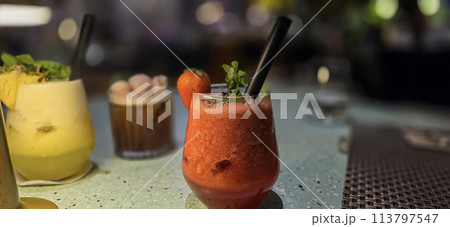 Fruit cocktail smoothie diet detox, tropical fruit summer cocktail with garnish, and ice on restaurant background 113797547